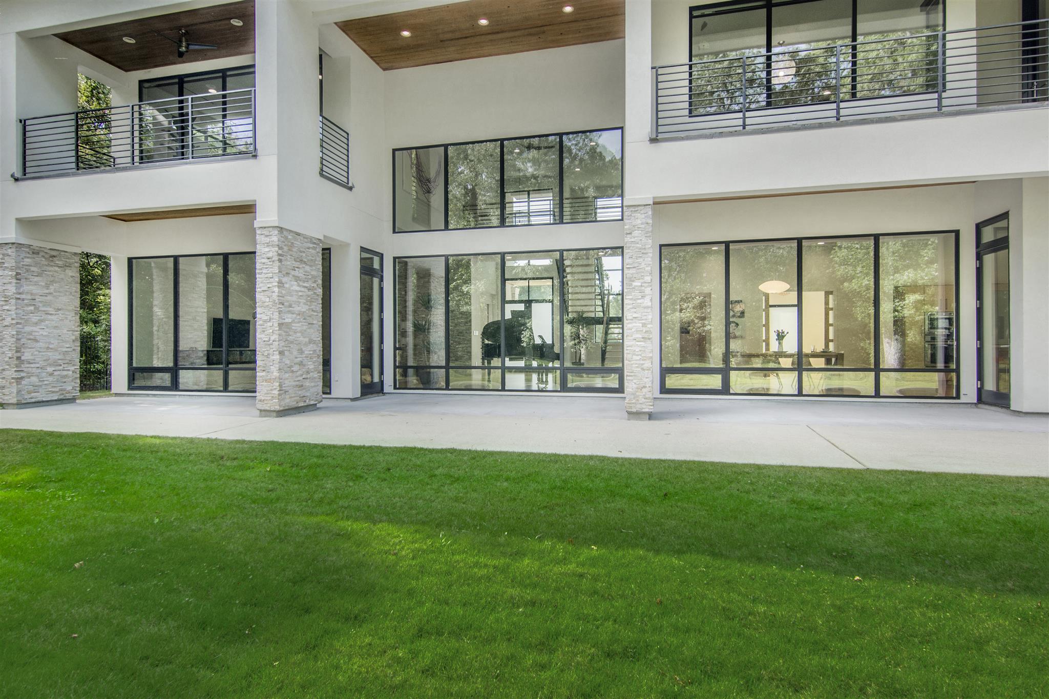 Rear exterior with large windows and green lawn